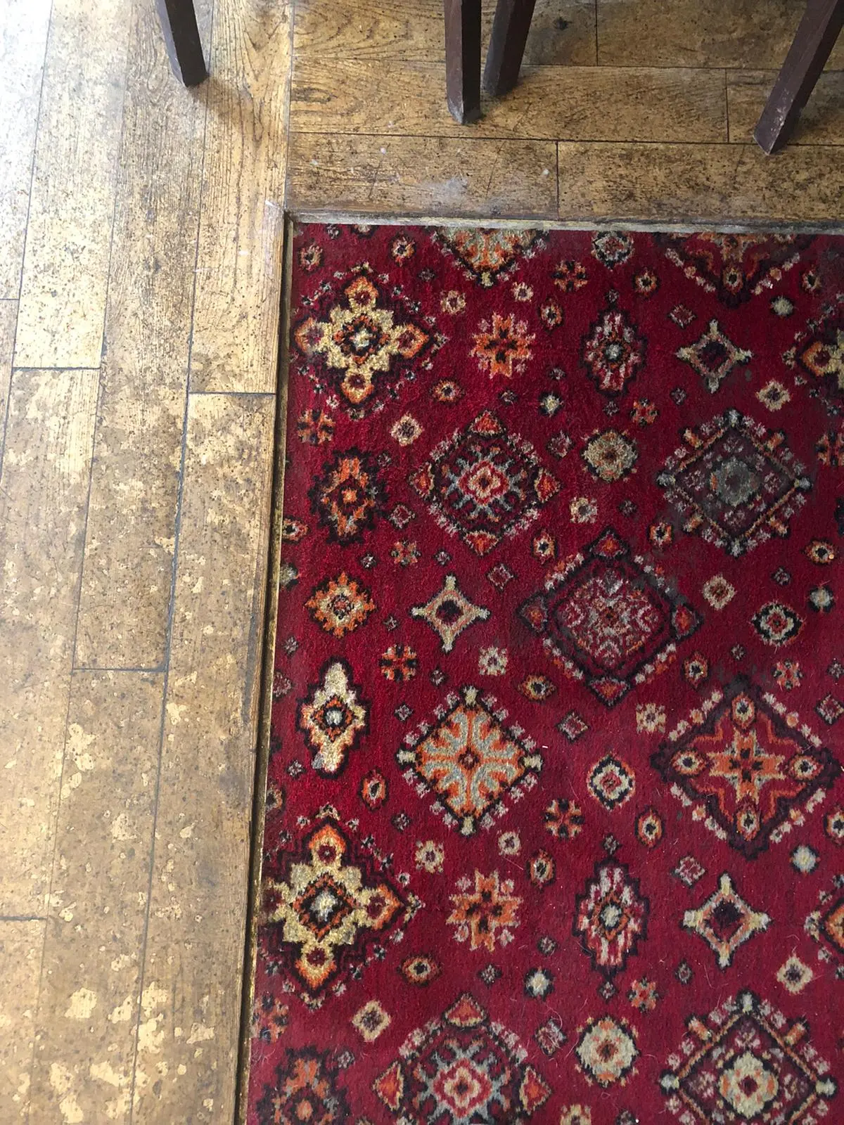 Traditional red patterned rug with colours restored after cleaning